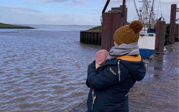 Ines with baby at the sea